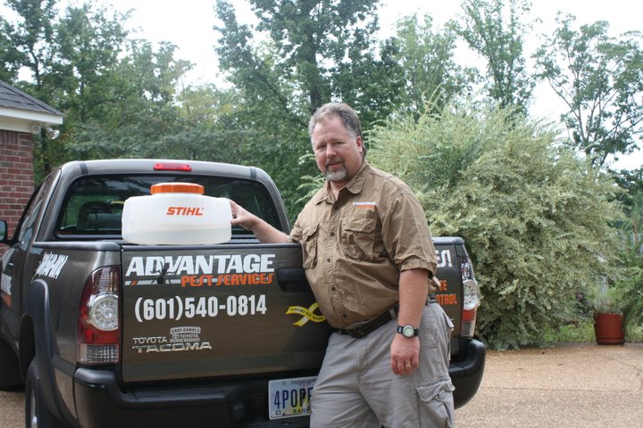 David McNeece, owner of Advantage Pest Services, beside the company truck in Madison MS